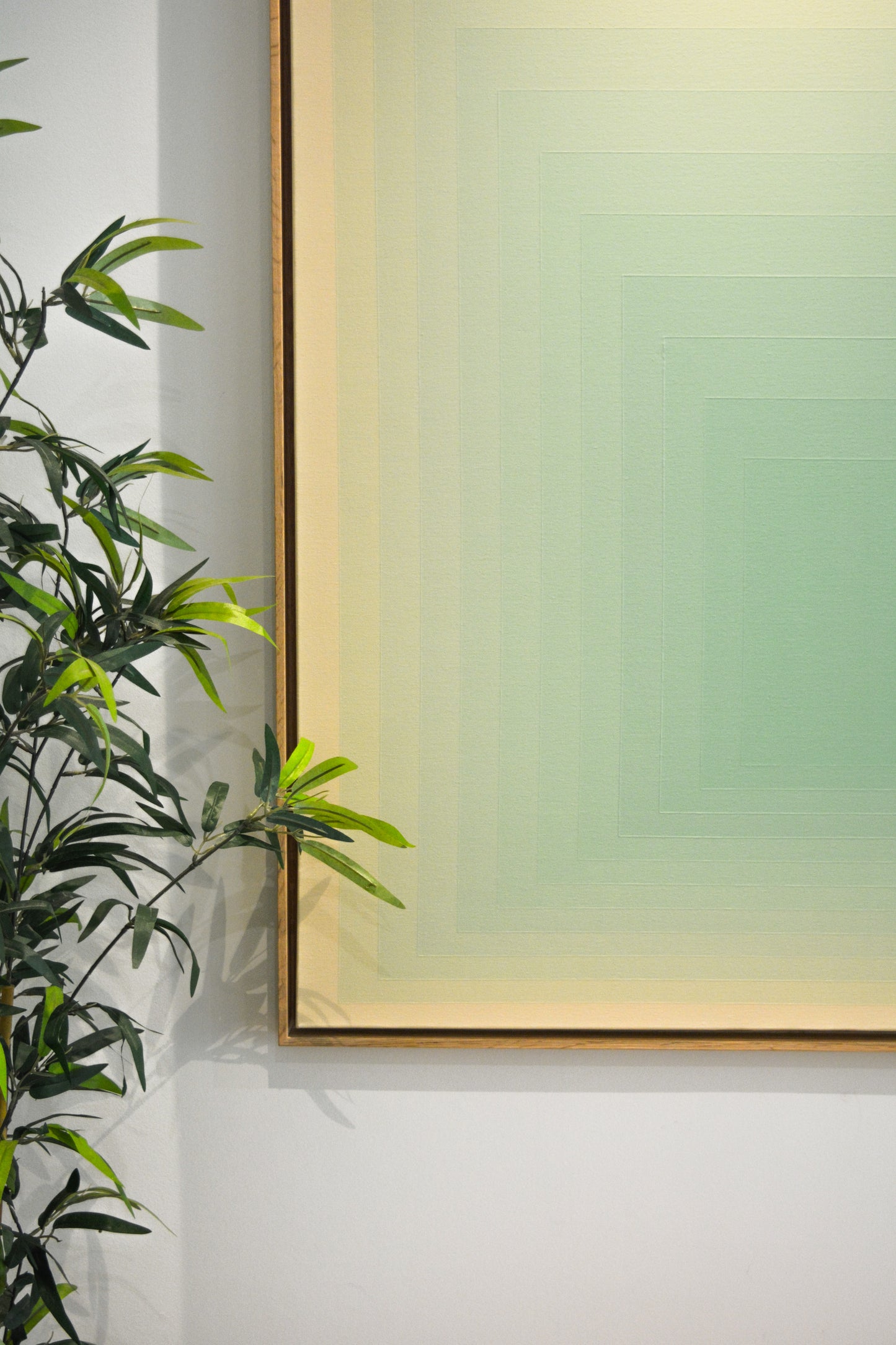 Abstract painting with concentric squares transitioning from light beige to soft lime green, creating a subtle gradient and minimalist design.