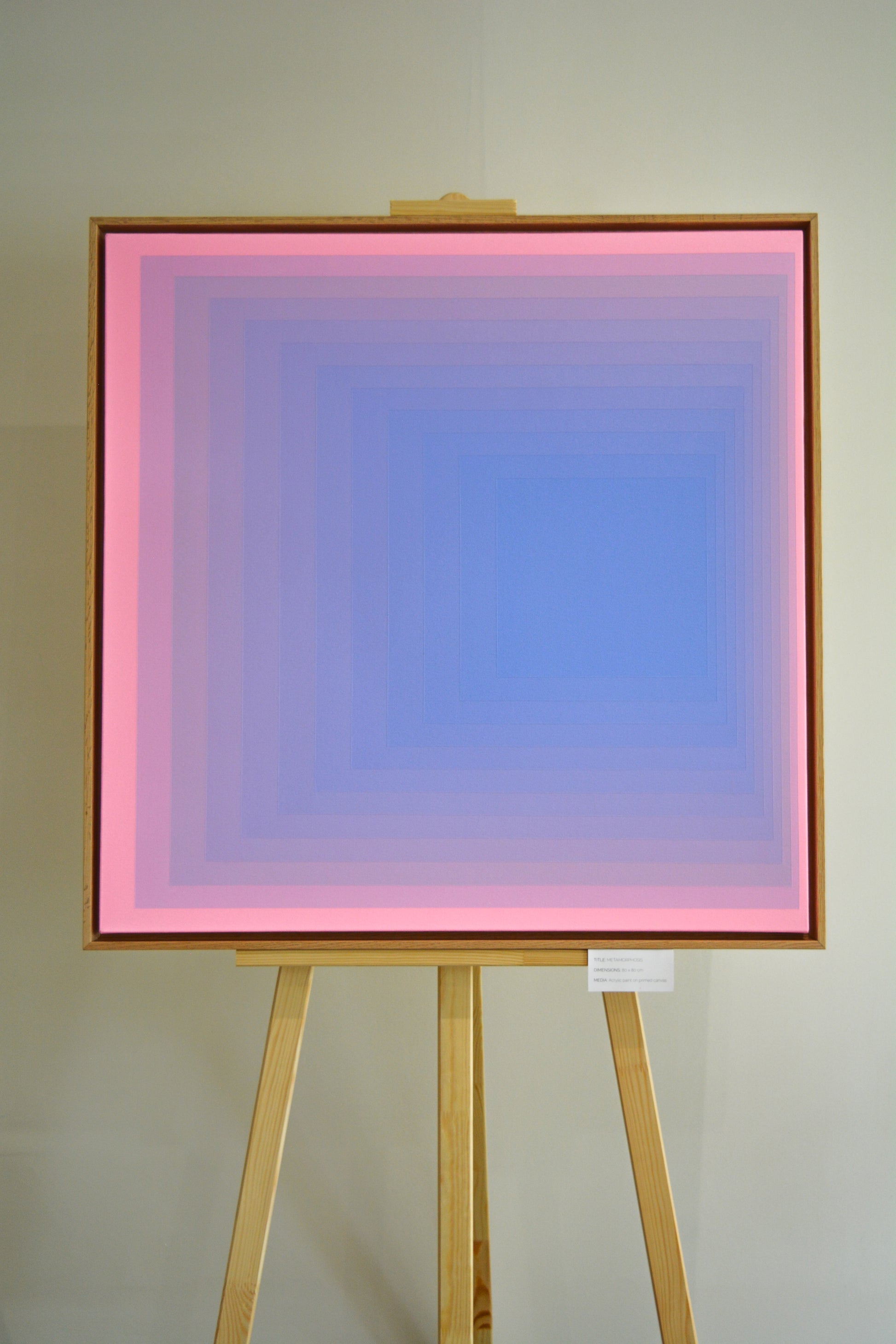 Abstract painting with concentric squares, transitioning from blue in the center to pink at the edges in a smooth gradient.