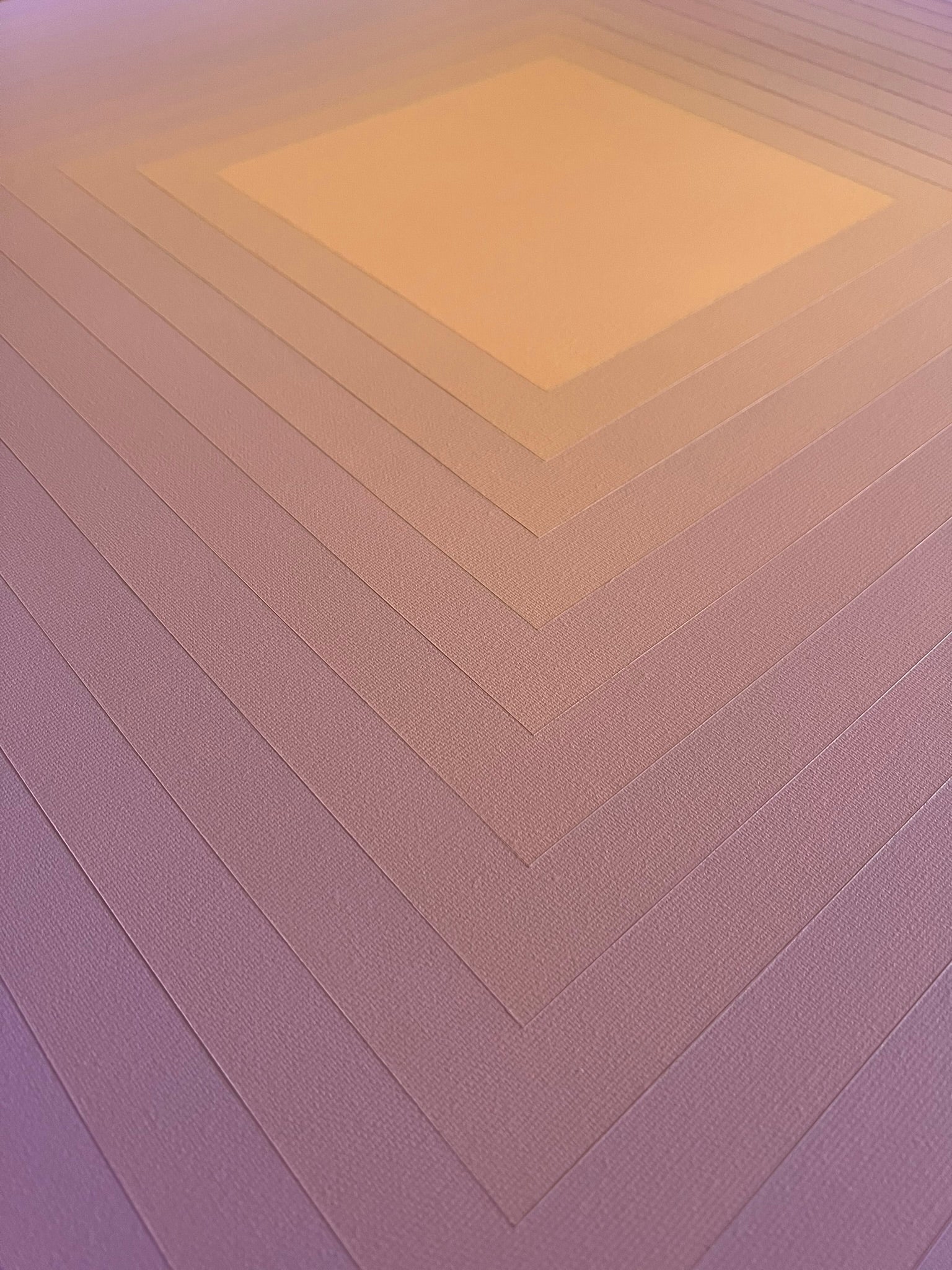 Abstract artwork with concentric squares transitioning from a peach center to lavender edges in a smooth gradient.